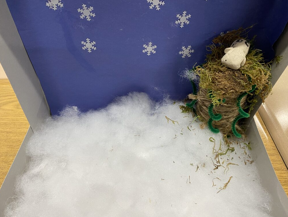 clay snowy owl in it's habitat - snowy field with tree