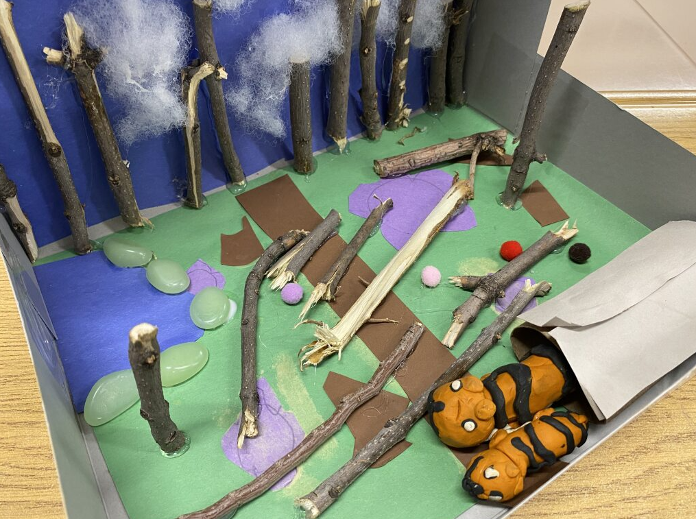 Two clay tigers in their habitat - forest/field