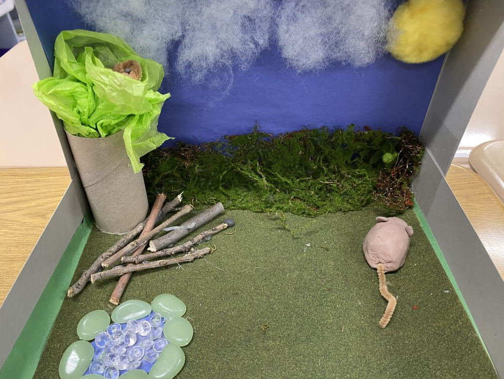 Clay mouse in it's habitat - field with a tree and some water