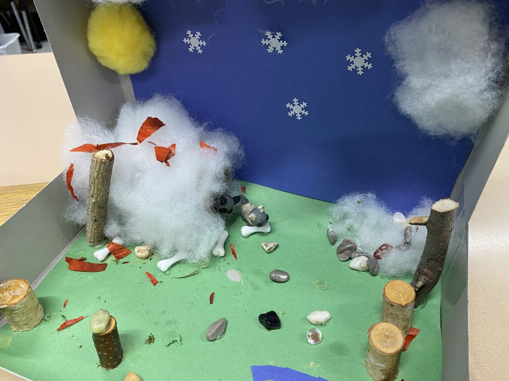 clay wolf in it's habitat - field with some snow