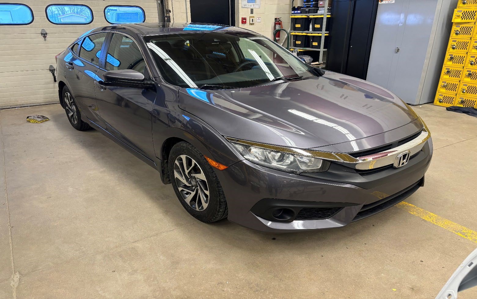 Photograph of a 2014 Honda Civic EX (Reconditioned) parked inside an automotive workshop.