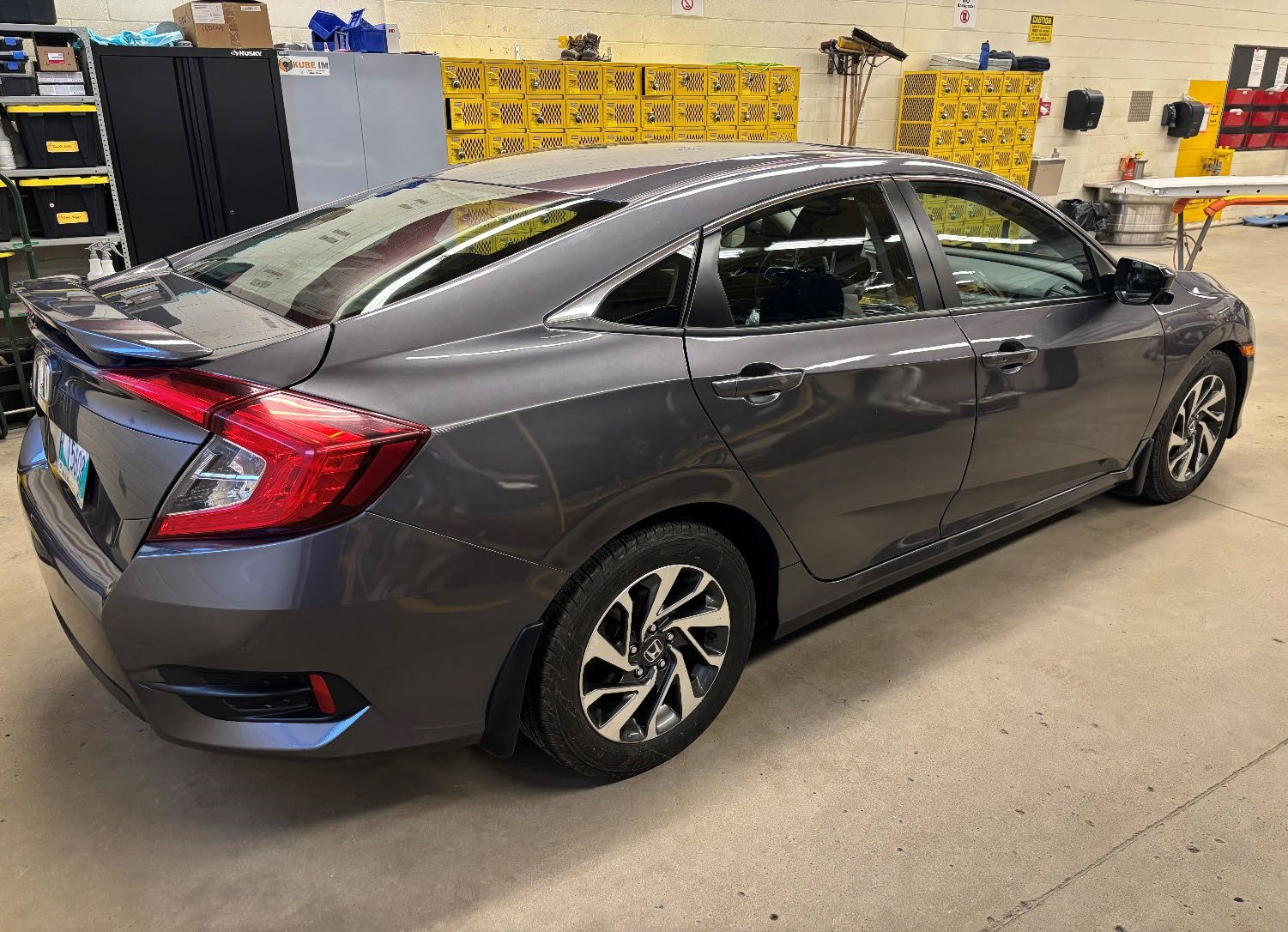 Photograph of a 2014 Honda Civic EX (Reconditioned) parked inside an automotive workshop.