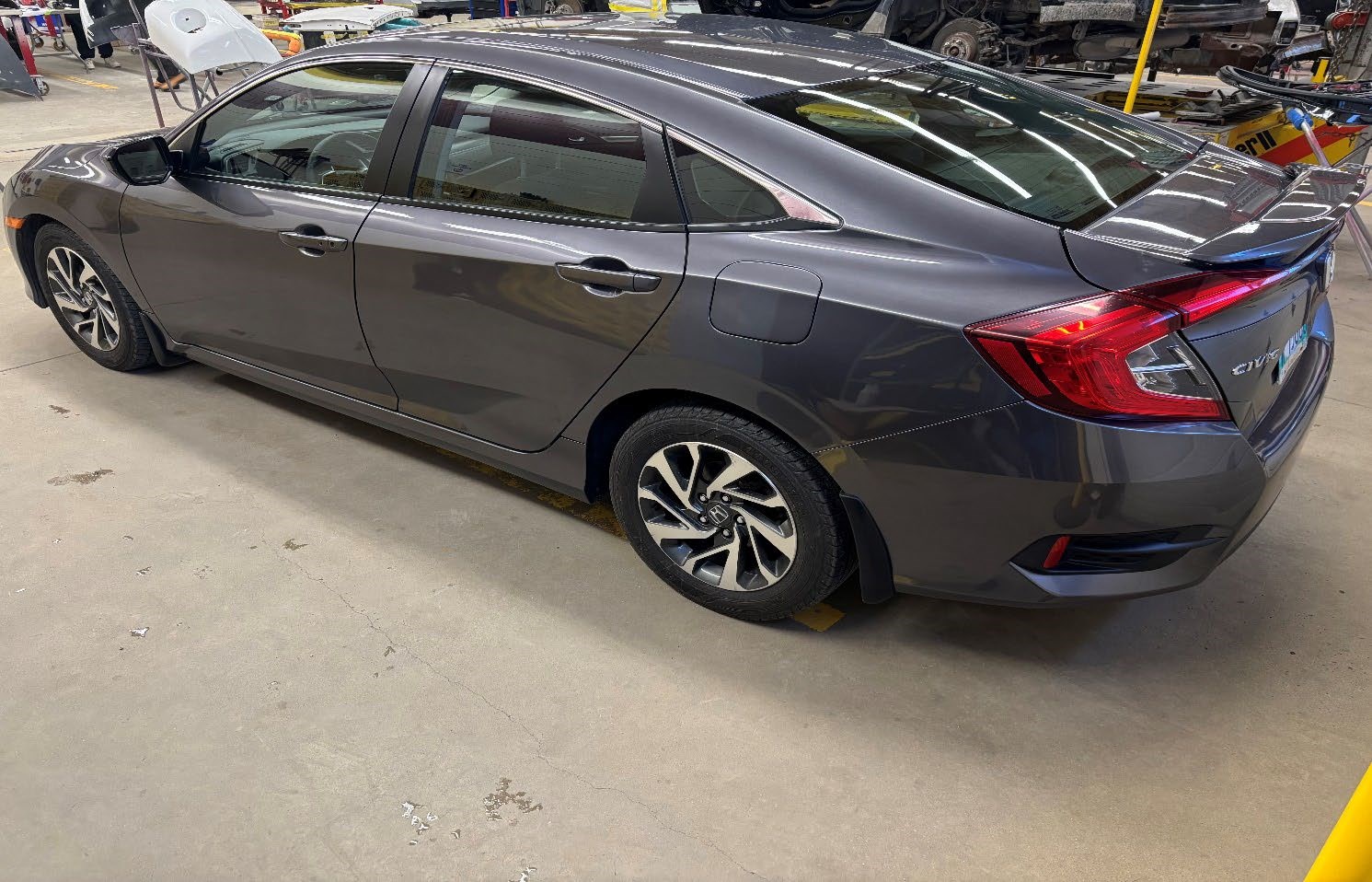 Photograph of a 2014 Honda Civic EX (Reconditioned) parked inside an automotive workshop.