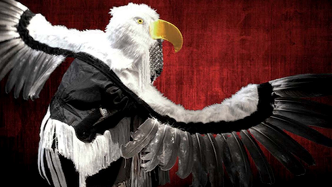 Image of an Indigenous Dancer dressed as an eagle with its wings spread out. 