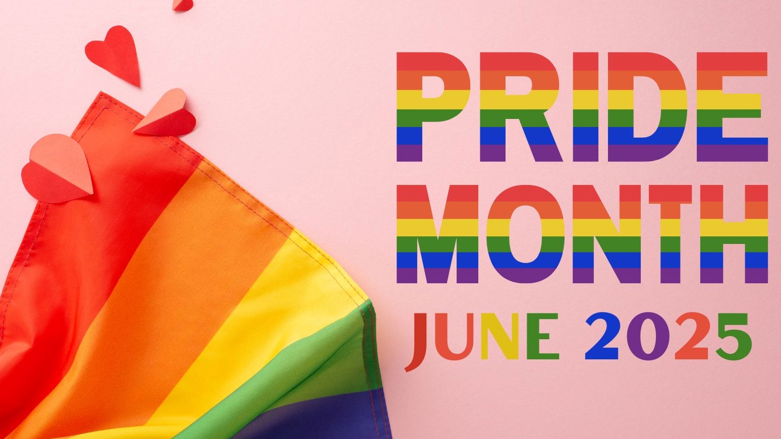 A Rainbow Pride Flag with paper hearts and text that reads “Pride Month – June 2025”
